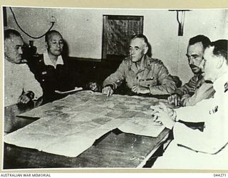 GENERAL STURDEE DISCUSSES JAPANESE TROOP DISPOSITIONS WITH GENERAL IMAMURA AND VICE-ADMIRAL KUSAKA AFTER THE SURRENDER OF JAPANESE FORCES AT RABAUL ON BOARD HMS GLORY, 1945-09-06