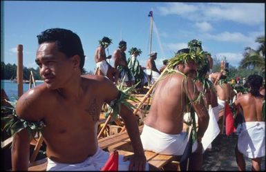 Group of men wearing white lava lava on boat