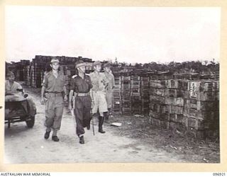KAHILI, BOUGAINVILLE. 1945-09-20. MAJOR F.A. GODING, BUIN LIAISON PARTY FROM HEADQUARTERS 2 CORPS, ACCOMPANIED BY JAPANESE OFFICERS, INSPECTING JAPANESE AMMUNITION DUMPS