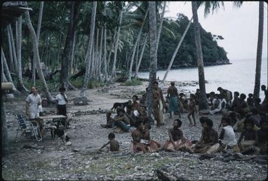 Colin Fisher (Malaria Control Officer) and Kairi Fae (Malaria Control Assistant) hold prespraying meeting with villagers at Igwageta village (1) : Fergusson Island, D'Entrecasteaux Islands, Papua New Guinea, 1959 / Terence and Margaret Spencer