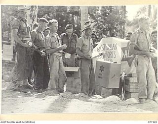 MADANG, NEW GUINEA. 1944-12-14. AUSTRALIAN TROOPS RECEIVING THEIR ISSUE OF AUSTRALIAN COMFORTS FUND GOODS IN A FRONT LINE AREA