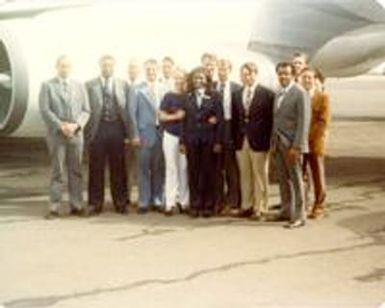 Group picture in front of a plane