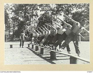 LAE, NEW GUINEA. 1944-11-11. A CLASS OF CONVALESCING PATIENTS UNDER INSTRUCTION BY CORPORAL S.C. ELLERINGTON, PHYSICAL TRAINING INSTRUCTOR, AT THE 112TH CONVALESCENT DEPOT