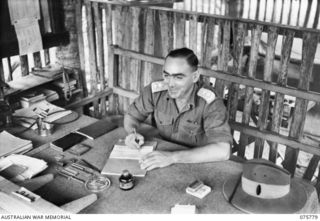 SIAR-NAGADA, NEW GUINEA. 1944-09-08. VX5172 LIEUTENANT-COLONEL W.R. DEXTER, DSO, COMMANDING OFFICER, 61ST INFANTRY BATTALION "THE QUEENSLAND CAMERON HIGHLANDERS" AT WORK IN HIS OFFICE