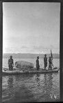 Men in canoe with a woven fish trap, New Britain; man on left holding paddle