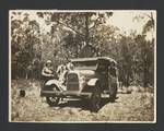 JK Murray, Evelyn Andrews, and a woman standing next to a motor vehicle, c1924