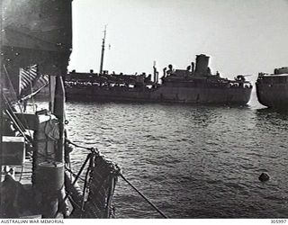 MILNE BAY, PAPUA. THE US TANKER PUEBLO, AGROUND ON DORISAI SHOAL, TRANSFERRING FUEL TO THE ROYAL AUSTRALIAN FLEET AUXILIARY TANKER BISHOPDALE BEFORE BEING TOWED OFF BY HMAS BROOME. (NAVAL ..