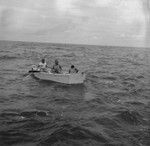 John D. Isaacs (middle), Willard Bascom (back to camera) and unidentified man in skiff, Bikini Atoll area