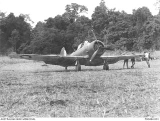 POPONDETTA AIRSTRIP, C.1942-12. WIRRAWAY AIRCRAFT OF NO.4 SQUADRON RAAF PERSONNEL LEFT TO RIGHT: FLYING OFFICER JOHN M. UTBER (401866) PILOT, CORPORAL SID McGIBBON FITTER IIE, CORPORAL STEVE ..