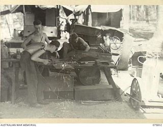 ALEXISHAFEN, NEW GUINEA. 1944-09-13. TROOPS OF THE 133RD BRIGADE WORKSHOPS, WORKING IN THE UNIT PANEL BEATING SHOP. IDENTIFIED PERSONNEL ARE: NX130542 CORPORAL H.J. SKELLY 91); NX19307 CRAFTSMAN V. ..