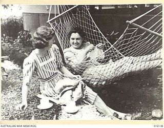 NEW GUINEA. 17 NOVEMBER 1943. AT AN AUSTRALIAN FIELD HOSPITAL MEMBERS OF THE AUSTRALIAN ARMY MEDICAL WOMEN'S SERVICE (AAMWS) NURSING SISTERS RELAX WITH A CUP OF TEA. IN THE HAMMOCK IS SISTER M.A. ..