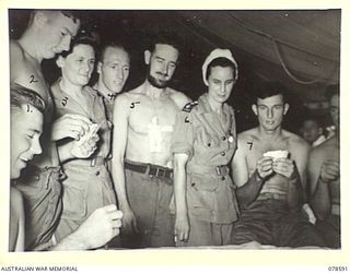 BOUGAINVILLE ISLAND. 1945-01-23. NFX136245 SISTER E. HORAN (1) AND QFX19161 SISTER E.M. ALLEN (2) WATCHING PATIENTS PLAYING CARDS AT THE 2/1ST AUSTRALIAN GENERAL HOSPITAL