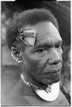 Man with dafi pearshell neck ornament, and plaited fari (spilt) comb with kwaloi'a porpoise tooth star, and leaf bespelled to protect him from sorcery at the feast