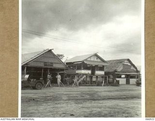 BUNA, NEW GUINEA. 1944-06-14/02. SHOWN ARE, HEADQUARTERS MOVEMENT CONTROL OFFICE (LEFT), DOCK SUPERINTENDENTS OFFICE (CENTRE) AND THE OFFICE OF THE 12TH WATER TRANSPORT OPERATING COMPANY