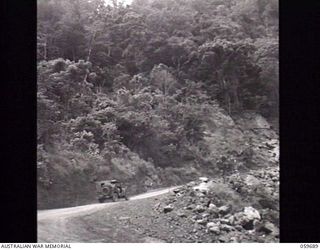 DONADABU, NEW GUINEA. 1943-10-07. JEEP VEHICLE ON A MOUNTAINOUS STRETCH OF ROAD BETWEEN DONADABU AND PORT MORESBY. AT THE BOTTOM OF THIS ROAD IS A HAIRPIN BEND