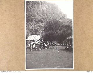 UBERI, NEW GUINEA. 1943-12-16. CAMP OF THE AUSTRALIAN MILITARY HISTORY SECTION FILM UNIT AND CHAUVEL'S PRODUCTIONS SET UP IN THE VILLAGE IN PREPARATION FOR SHOOTING THE FINAL SEQUENCES OF THE ..