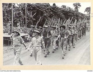 LAE AREA, NEW GUINEA, 1945-06-16. LT-GEN V.A.H. STURDEE, GOC FIRST ARMY (1), TAKING THE SALUTE FROM 13 WORKS AND PARK COMPANY, DURING A PARADE, ATTENDED BY ALL ENGINEER COMPANIES UNDER THE COMMAND ..