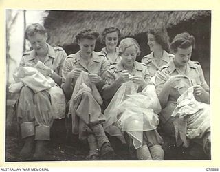 NEW BRITAIN. 1945-03-1945. THE FIRST MEMBERS OF THE ARMY MEDICAL WOMEN'S SERVICE TO TAKE UP DUTY IN NEW BRITAIN MAKE TABLE COVERS AND OTHER ARITCLES FOR USE IN THEIR MESS HALL. IDENTIFIED PERSONNEL ..