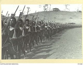 BISIATABU, NEW GUINEA. 1944-04-19. MEMBERS OF THE ROYAL PAPUAN CONSTABULARY MARCHING WITH PRECISION AT THEIR TRAINING DEPOT DURING A SPECIAL PARADE HELD IN HONOUR OF THE VISIT TO THE AREA OF THE ..