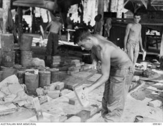 TOROKINA, BOUGAINVILLE, 1945-12-03. PRIVATE W. MCGINNISKIN (1) ATTENDING A COURSE IN THE BRICKLAYING SECTION, AT THE TOROKINA REHABILITATION TRAINING CENTRE