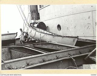 OFF PORT MORESBY, PAPUA. 1942-08-30. THIS LIFEBOAT OF THE M.V. MALAITA, LYING ACROSS THE FORE HATCH WAS BLOWN BY THE EXPLOSION OF AN ENEMY TORPEDO, FROM THE BOAT DECK AMIDSHIPS, OVER THE BRIDGE AND ..