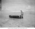 Mr. Rudolph Tuiasosopo next to raft used for transporting clams, Bikini Atoll, 1947
