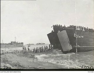 AITAPE, NORTH EAST NEW GUINEA. 1944-04-22. RAAF ENGINEERS WHO LANDED WITH AMERICAN ASSAULT TROOPS UNLOAD ON THE BEACH LANDING SHIP, TANK (LST), NO. 474, WHICH BROUGHT THEIR HEAVY EQUIPMENT