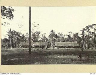 LAE, NEW GUINEA. 1944-03-25. ONE OF ADJOINING PHOTOGRAPHS SHOWING THE OFFICERS' MESS, OFFICERS' QUARTERS AND QUARTERS UNDER CONSTRUCTION AT HEADQUARTERS LAE BASE SUB-AREA. THE RECREATION GROUND IS ..