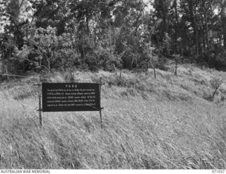 PABU, NEW GUINEA. 1944-03-13. ONE OF MANY BATTLE SIGNS IN THE FINSCHHAFEN AREA, THIS SIGN RECORDS ACTIVITIES OF THE 2/32ND AND 2/43RD INFANTRY BATTALIONS. THIS TIMBERED RIDGE OVERLOOKING THE ..