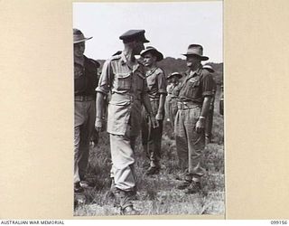 LAE, NEW GUINEA, 1945-12-01. COLONEL G.H.S MORAN (1) INSPECTING TROOPS OF 2/1 BASE WORKSHOP, ON THE OCCASION OF THE THIRD ANNIVERSARY OF THE FORMATION OF THE CORPS OF AUSTRALIAN ELECTRICAL AND ..