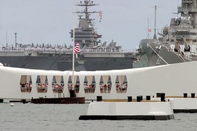 US Navy (USN) Sailors aboard the USN Nimitz Class Aircraft Carrier USS JOHN C. STENNIS (CVN 74) render honors as they pass the USS ARIZONA Memorial and the Battleship MISSOURI (BB 63) Memorial Pearl Harbor, Hawaii. The STENNIS and Carrier Air Wg 14 (CVW-14) are takg part Rim of the Pacific (RIMPAC) 2004. RIMPAC is the largest ternational maritime exercise the waters around the Hawaiian Islands. This years exercise cludes seven participatg nations: Australia, Canada, Chile, Japan, South Korea, the United Kgdom and the United States. RIMPAC enhances the tactical proficiency of participatg units a wide array of combed operations at sea, while enhancg stability...