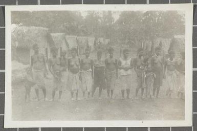 A large group of indigenous women and children outside huts in the village of Nissan