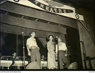 TOROKINA, BOUGAINVILLE ISLAND, SOLOMON ISLANDS. C. 1945-02-23. AT THE THEATRE, LEFT TO RIGHT, 70272 FLYING OFFICER HARRY DEARTH, SYDNEY, NSW, 10807 SERGEANT (SGT) BREN MAGEE, MELBOURNE, VIC, 119629 ..