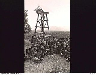 KAIAPIT, NEW GUINEA. 1943-09-23. MEN OF THE 2/6TH AUSTRALIAN CAVALRY (COMMANDO) SQUADRON PATCHED UP THE BELLOWS OF THIS BULLET RIDDLED ORGAN FROM THE KAIAPIT LUTHERAN MISSION AND HAD A SING SONG ON ..