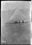 Men on Kiribati canoe with sail