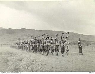 MARKHAM VALLEY, NEW GUINEA 1944-08-28. MEMBERS OF NO. 11 BATTERY, 4TH FIELD REGIMENT, MARCHING ON TO THE UNIT PARADE GROUND FOR AN INSPECTION BY THE GENERAL OFFICER COMMANDING, 3RD DIVISION. ..