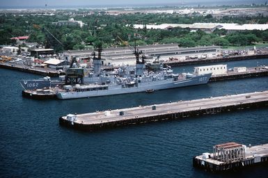 A starboard view of the frigate USS OUELLET (FF 1077) and a port bow view of the frigate USS WHIPPLE (FF 1062) docked at Bravo Piers