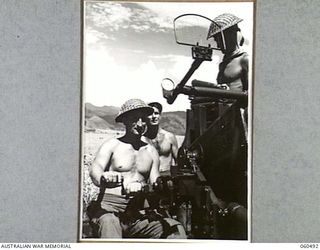 DUMPU AIRSTRIP, NEW GUINEA, 1943-11-14. A 40MM BOFORS ANTI-AIRCRAFT GUN OF THE 2/4TH AUSTRALIAN LIGHT ANTI-AIRCRAFT REGIMENT READY FOR ACTION. SHOWN ARE: WX13928 GUNNER J. T. BELL (1); SX12632 ..