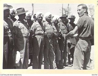 LAE, NEW GUINEA. 1945-06-09. INDIAN TROOPS, EVACUATED PRISONERS OF WAR WHO HAVE BEEN RECUPERATING AT 2/7 GENERAL HOSPITAL, BEING CHECKED OFF PRIOR TO MOVEMENT TO THE HOSPITAL SHIP MANUNDA