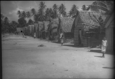 The village in black and white: note coils of pandanus leaf for mat-making (1) : Mortlock Islands, Papua New Guinea, 1960 / Terence and Margaret Spencer