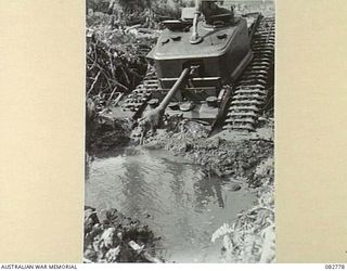 MADANG, NEW GUINEA. 1944-10. A CHURCHILL VII TANK BOGGED IN MUD AND WATER DURING TESTS CONDUCTED AT HQ 4 ARMOURED BRIGADE