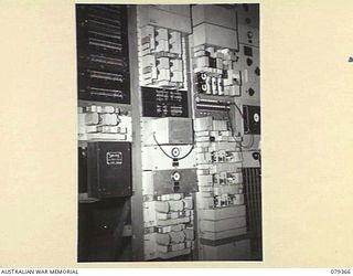 LAE, NEW GUINEA. 1945-03-11. A C55 CARRIER TELEPHONE SYSTEM, SHOWING THE POWER SUPPLY AND SUB CYCLE RANGER AT THE 19TH LINES OF COMMUNICATION SIGNALS