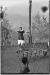 Unidentified white man practicing archery near Cooks' house in Kwiop