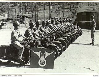 BARRINE, QLD. 1943-10-30. LINED UP WITH THEIR MOTOR CYCLES TO RECEIVE THEIR INSTRUCTIONS FOR THE DAY, A PORTION OF THE 2/2ND AUSTRALIAN DESPATCH RIDER SECTION "A" AUSTRALIAN CORPS OF SIGNALS AFTER ..