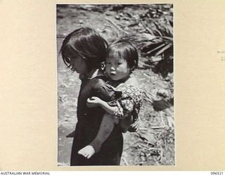 RABAUL AREA, NEW BRITAIN. 1945-09-13. CHINESE CIVILIANS, INTERNED BY THE JAPANESE AT A CAMP 15 MILES WEST OF RABAUL, WERE CONTACTED BY A PARTY OF AUSTRALIAN ARMY AND RED CROSS OFFICIALS SOON AFTER ..