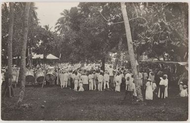 People in white watching a performance