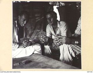 CAPE WOM, NEW GUINEA. 1945-09-27. WALKING PATIENTS AT 2/7 FIELD AMBULANCE PASSING THE TIME PLAYING CARDS. IDENTIFIED PERSONNEL ARE:- PRIVATE R. JENNINGS (1); PRIVATE R.A. BULLIVANT (2); PRIVATE ..