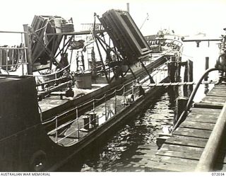 MILNE BAY, NEW GUINEA. 1944-04-05. THE UNITED STATES ARMY COASTAL TANKER Y - 18 SHOWING A LOW WATER LINE AFTER RECEIVING AVIATION FUEL FROM SHORE INSTALLATIONS AT THE 2ND AUSTRALIAN BULK PETROLEUM ..