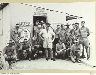 1943-03-25. NEW GUINEA. POPEYE THE SAILOR IS THE MASCOT OF THE MARINE SECTION OF RAAF HERE IS A GROUP OF SEAGOING AIRMEN AT A BASE IN NEW GUINEA, IN THE CENTRE BEING F/O J. CASSEL. THE MASCOT ..