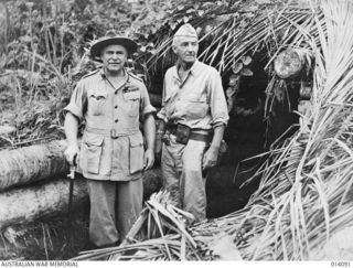 BUNA, PAPUA NEW GUINEA, 1943-01. GENERAL SIR THOMAS BLAMEY AND LIEUTENANT-GENERAL R. L. EICHELBERGER AT THE ENTRANCE TO A JAPANESE PILLBOX NEAR THE BUNA AIRSTRIP